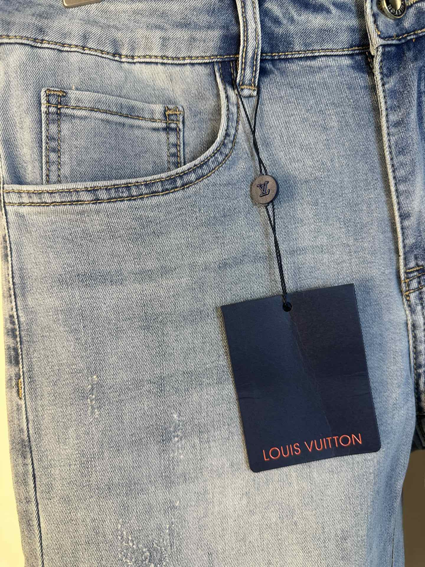 Louis Vuitton denim pants close-up, stitched front pocket and leather brand tag