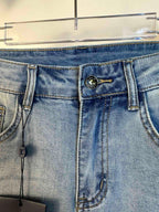 Louis Vuitton jeans waistband close-up with logo button, belt loops, coin pocket