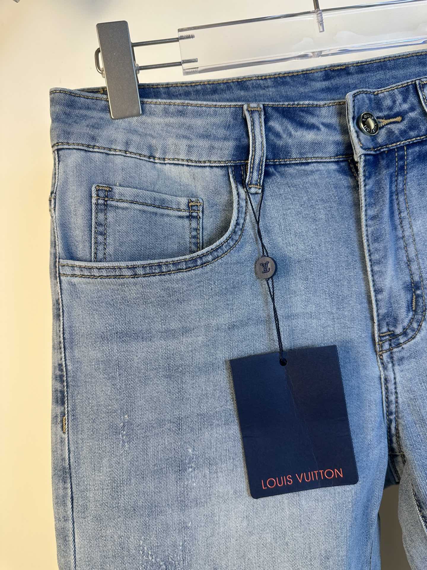Louis Vuitton denim pants back view, patch back pockets and logo tag