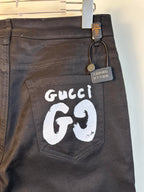 Black pants with large white GG69 logo patch on back pocket area