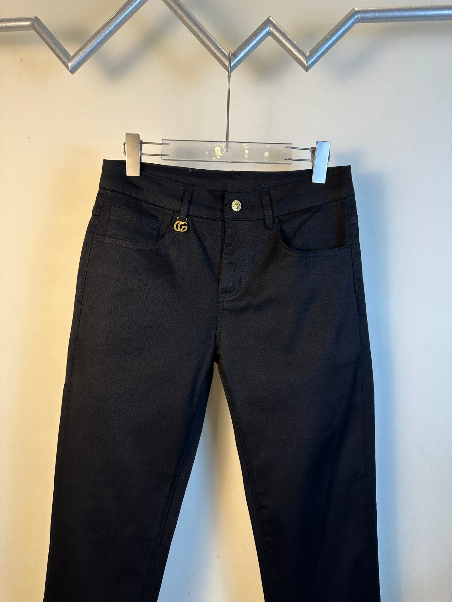 Gucci pants with black denim, button waistband, and gold GG emblem
