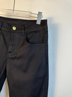 Black pants close-up of front pocket, waistband button, and belt loops