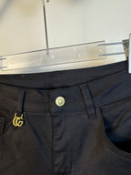 Black pants close-up of waistband and button with gold GG emblem