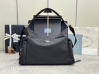 Prada bag in dark nylon with top handles, logo plaque, and zip closure