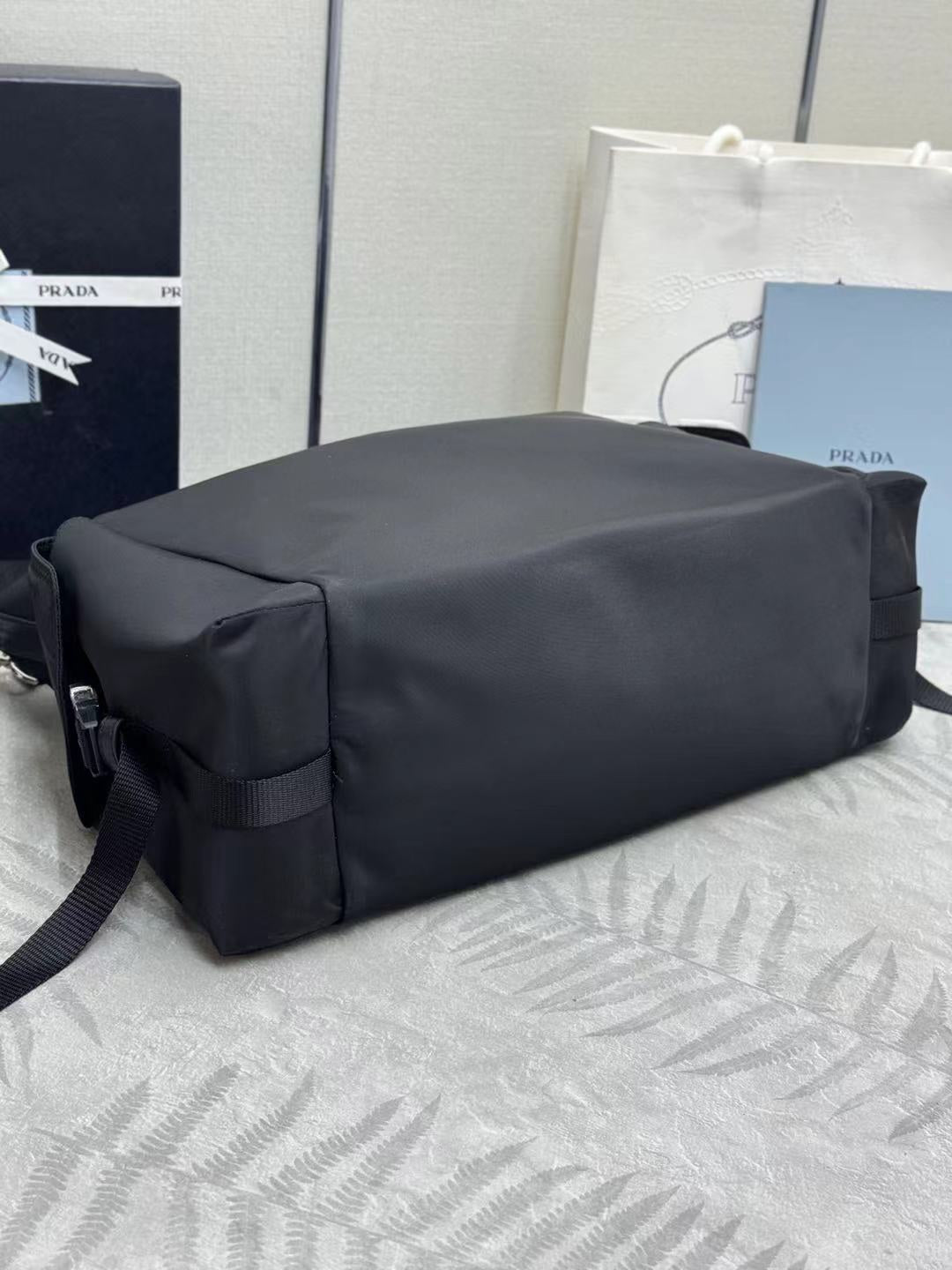 Prada bag in dark nylon with structured back panel and shoulder strap