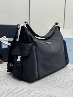 Prada bag in dark nylon with shoulder strap and front zip pocket