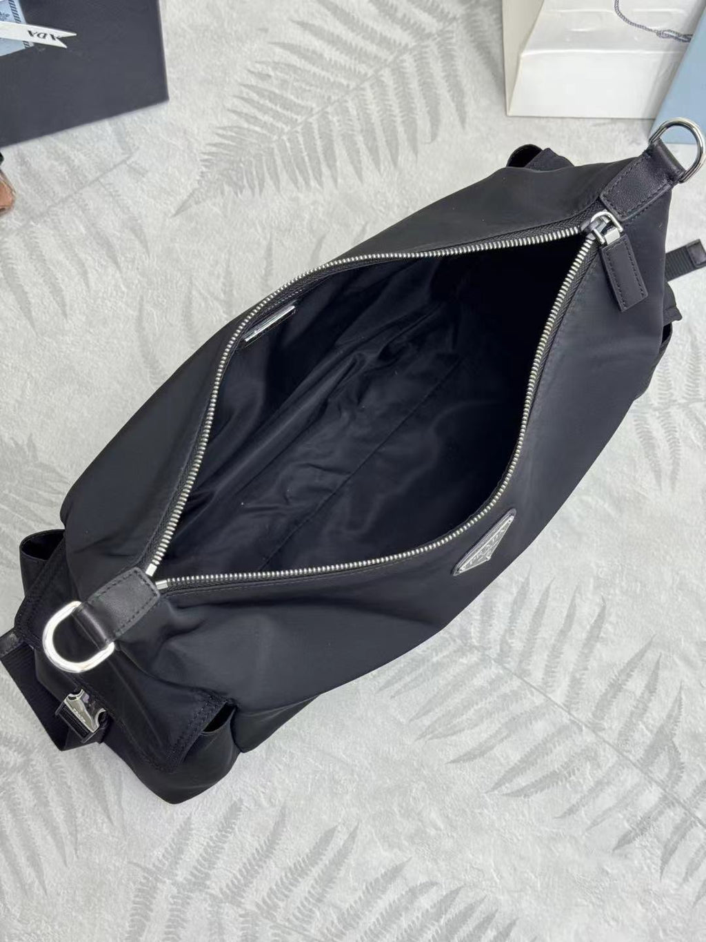 Prada bag in dark nylon with zip opening, interior lining, and shoulder strap