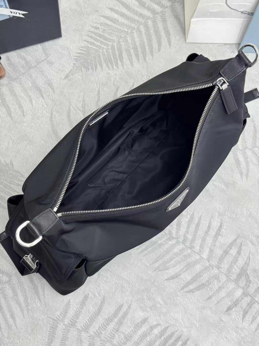 Prada bag in dark nylon with zip opening, interior lining, and shoulder strap