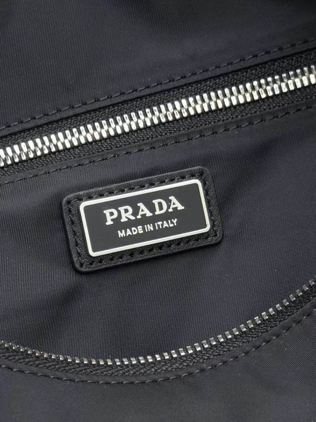 Prada "Made in Italy" label on dark nylon zip pocket