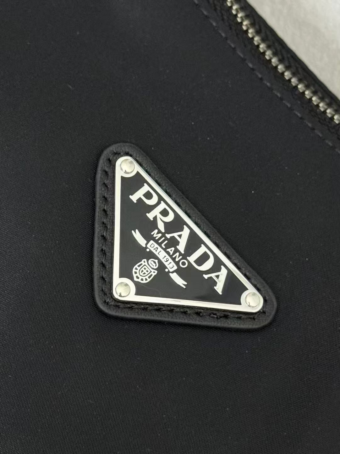 Prada logo leather patch on black nylon bag, Milano Italy