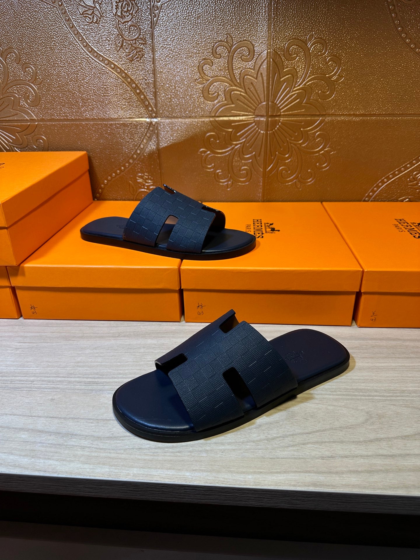 Blue slide sandals pair with wide cross straps, angled views
