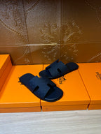 Blue slide sandals with embossed strap detail and open toe