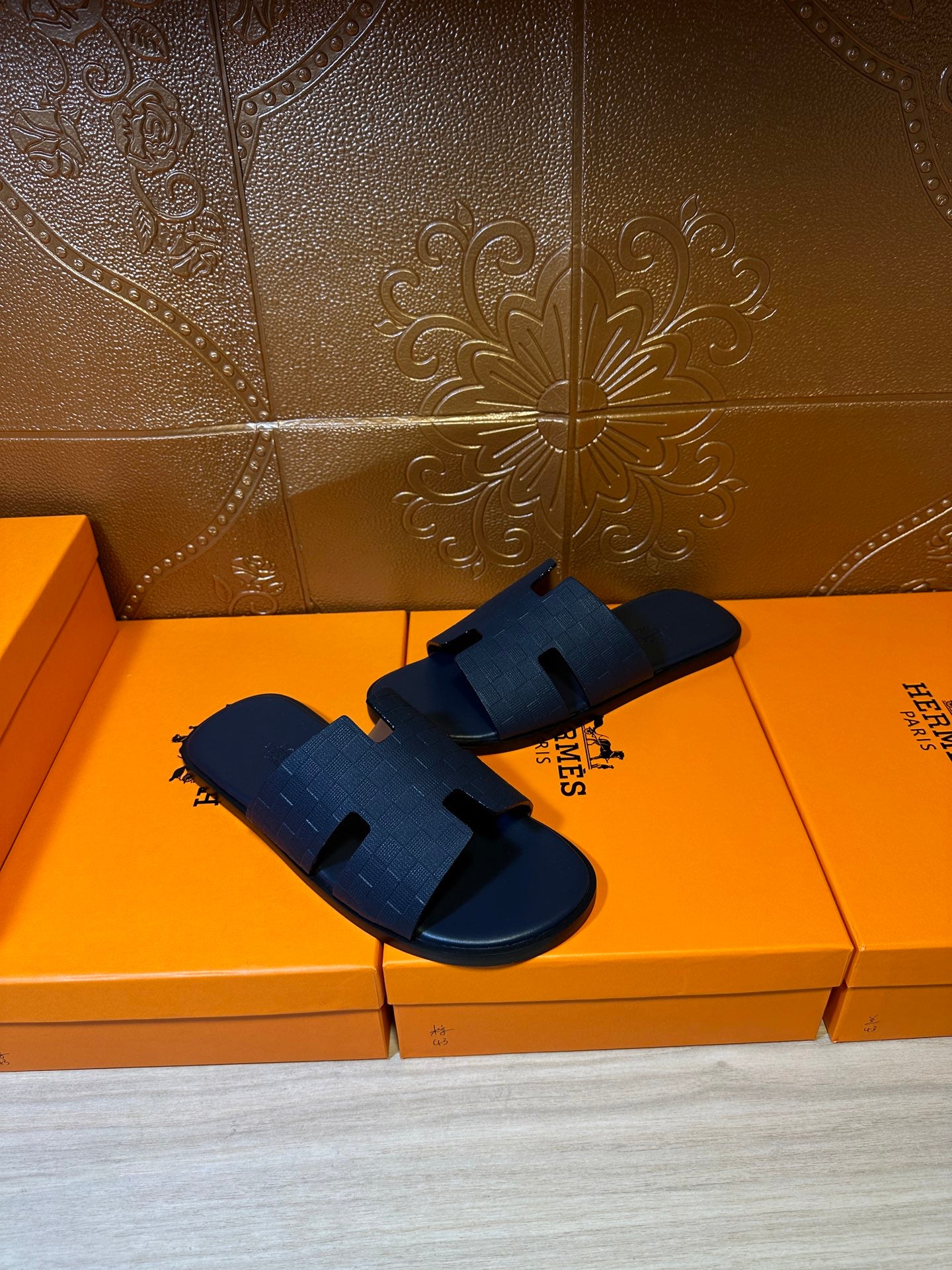 Blue slide sandals with embossed strap detail and open toe