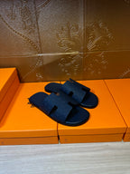 Blue slide sandals with wide cross straps and textured footbed