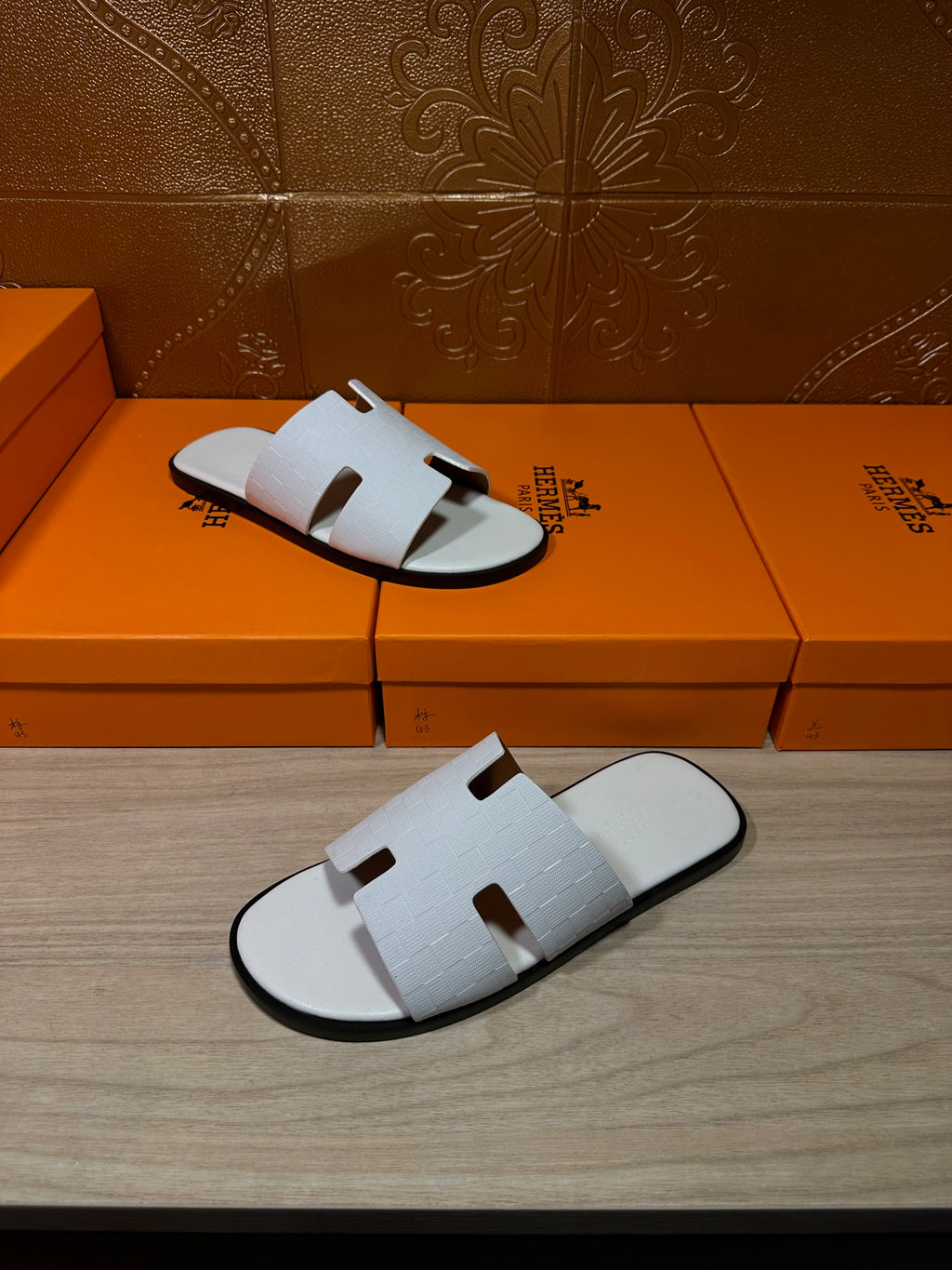 Hermes leather sandals in white, open-toe slides with textured strap panels