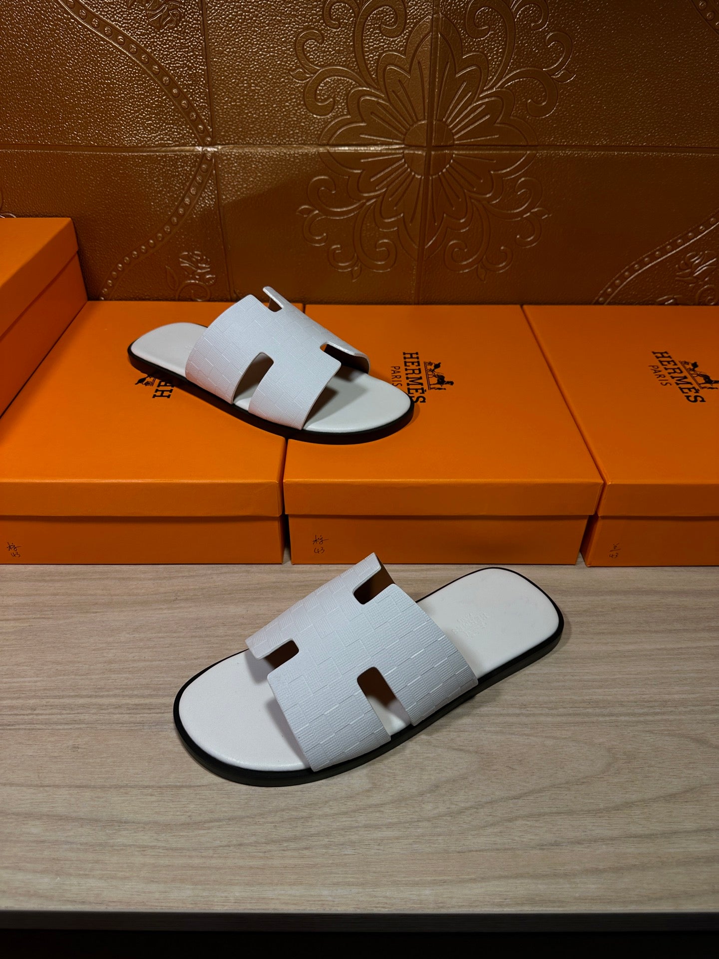 Hermes leather sandals in white, open-toe slides with textured strap panels