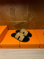 Hermes beige and black slide sandals, front view with black footbed