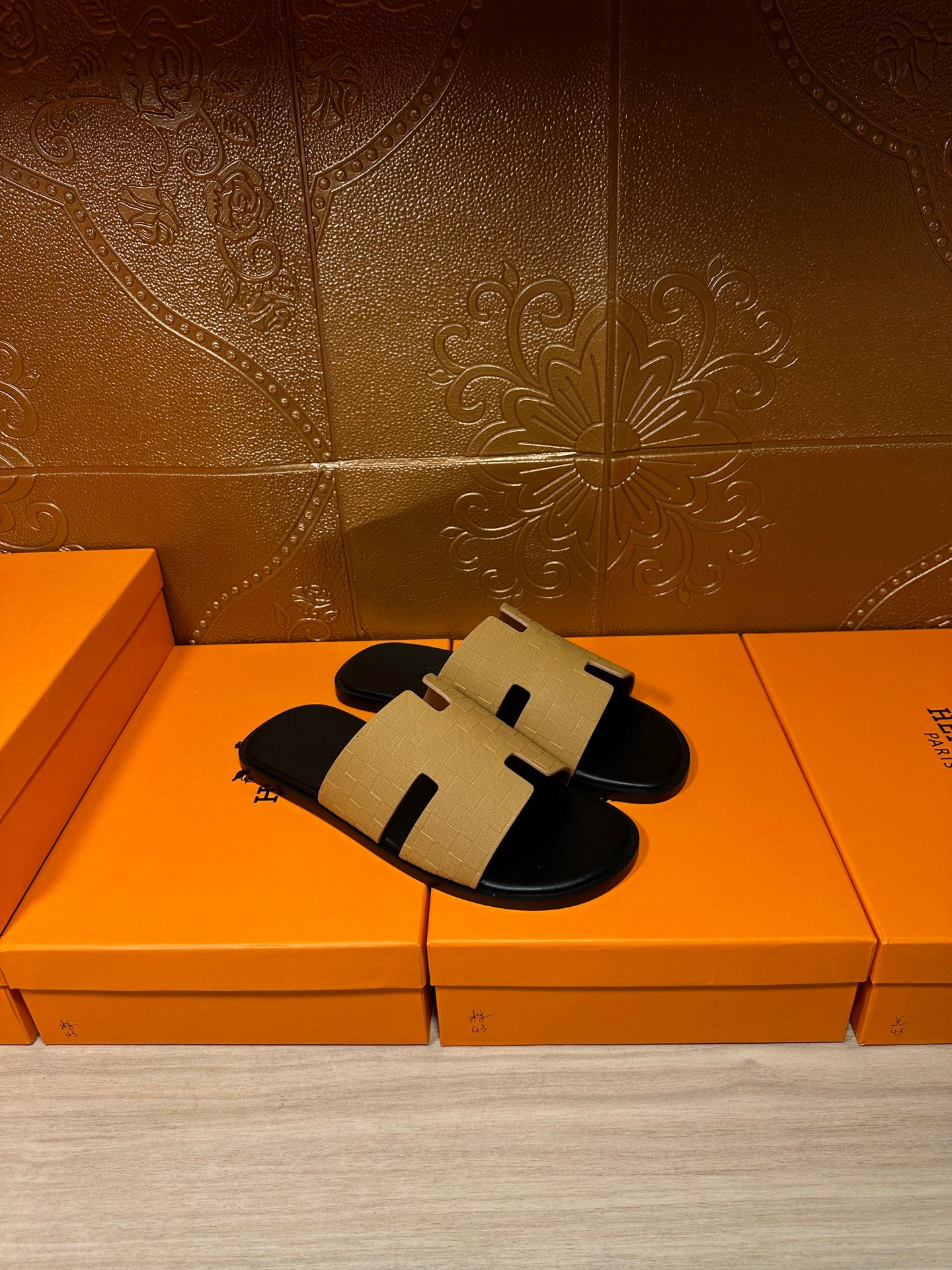 Hermes beige and black slide sandals, front view with black footbed