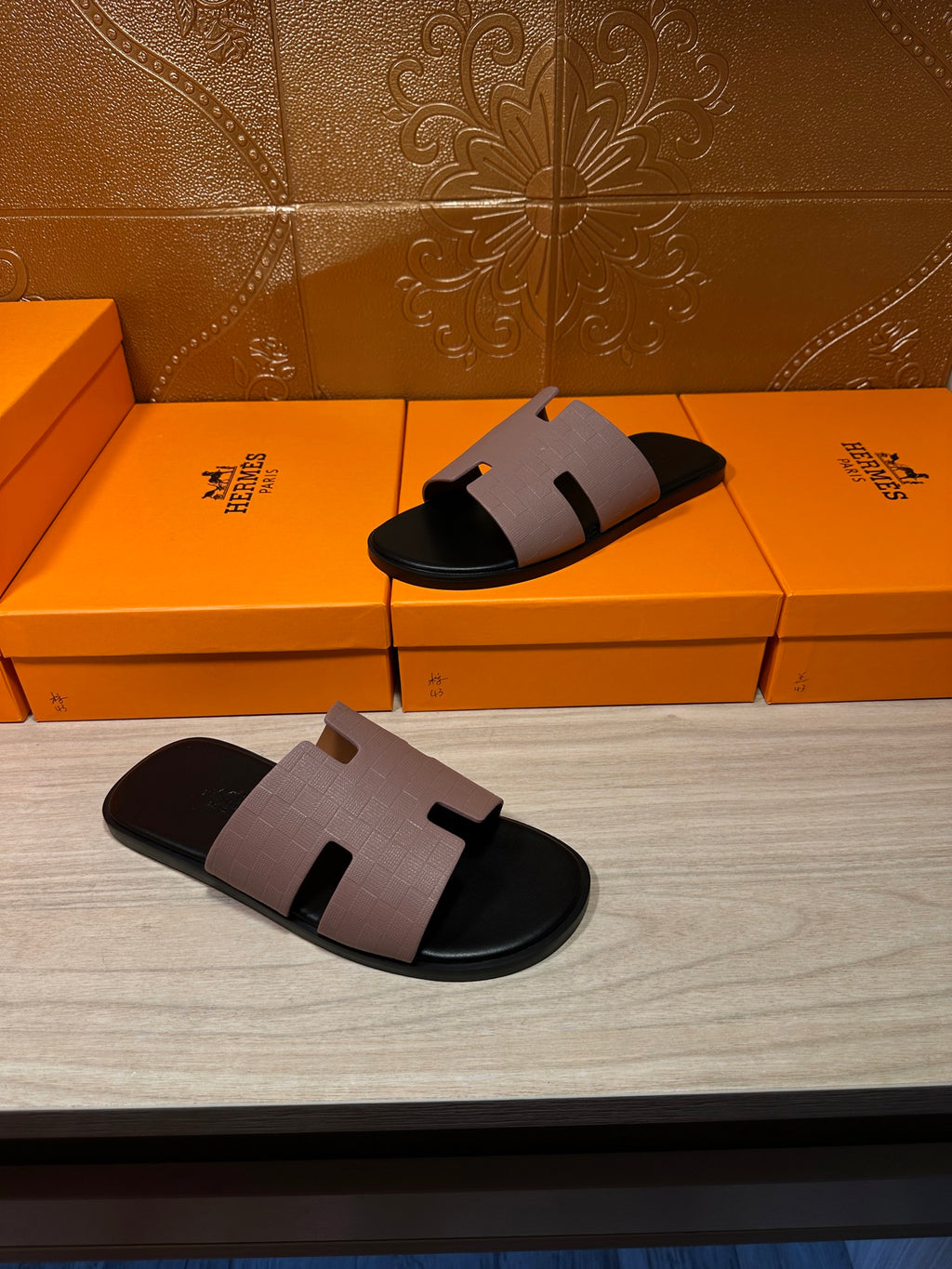 Two black slide sandals with light gray wide strap, squared open-toe top