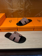Two black slide sandals with light gray wide strap, squared open-toe top