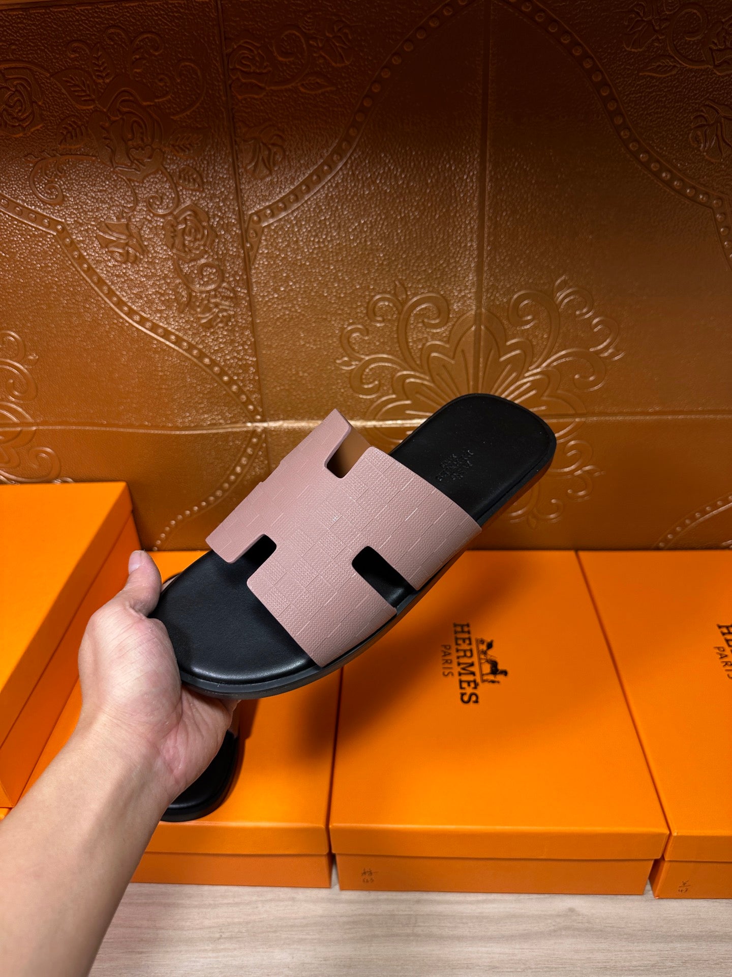 Single black slide sandal with light gray wide H-style strap across the top