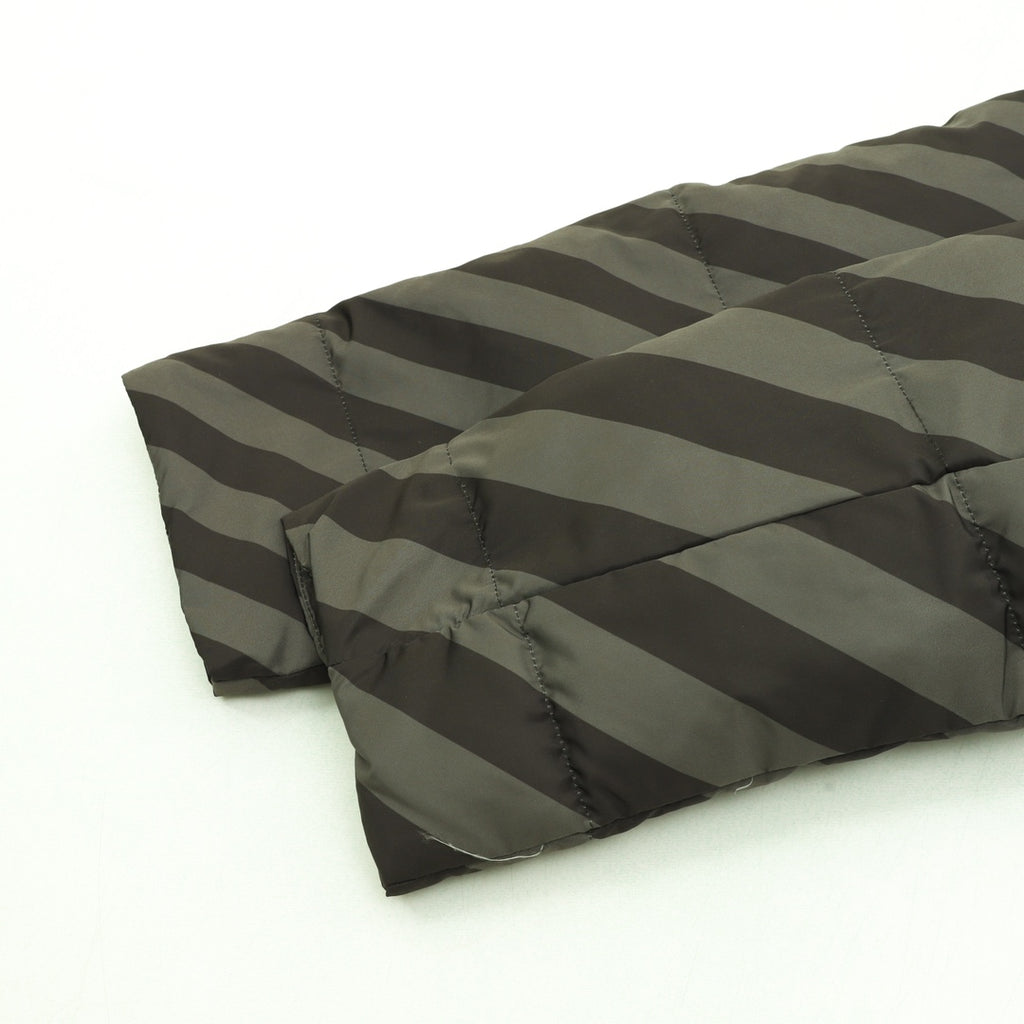 Fendi long puffer jacket side view showing diagonal stripe quilting and padded hem