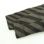 Fendi long puffer jacket side view showing diagonal stripe quilting and padded hem