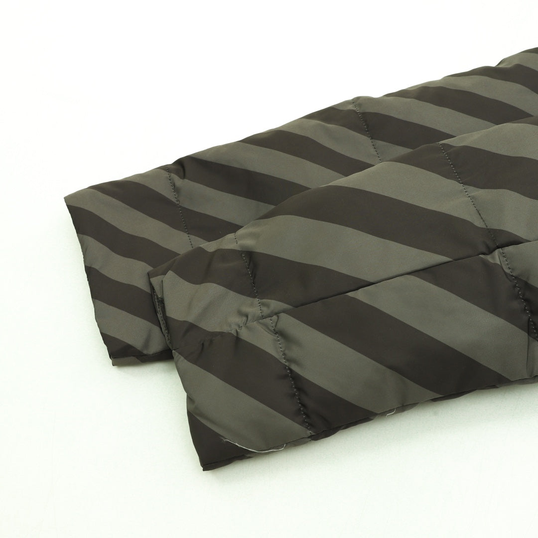 Fendi long puffer jacket side view showing diagonal stripe quilting and padded hem