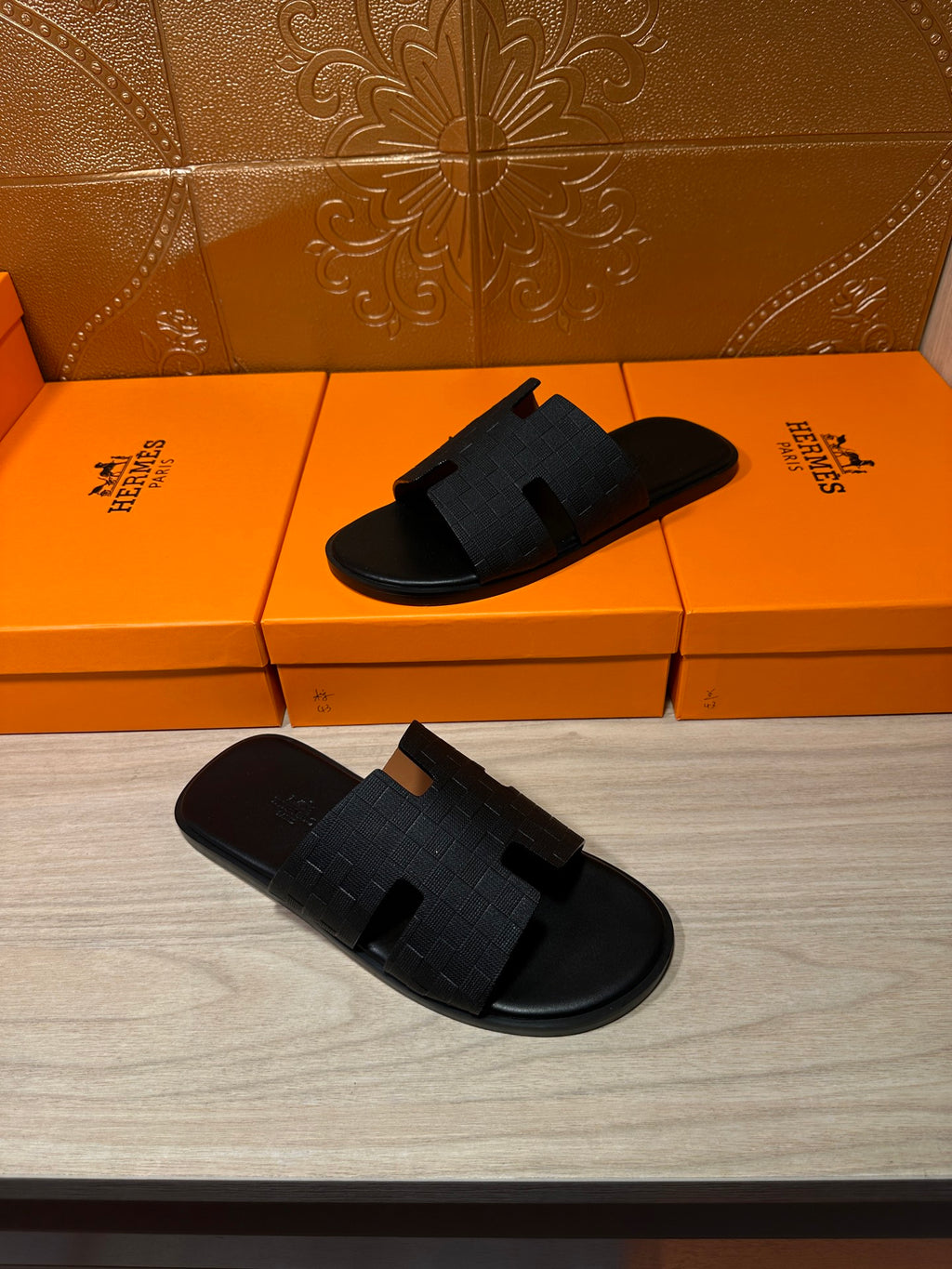 Black slide sandals pair with textured cross straps