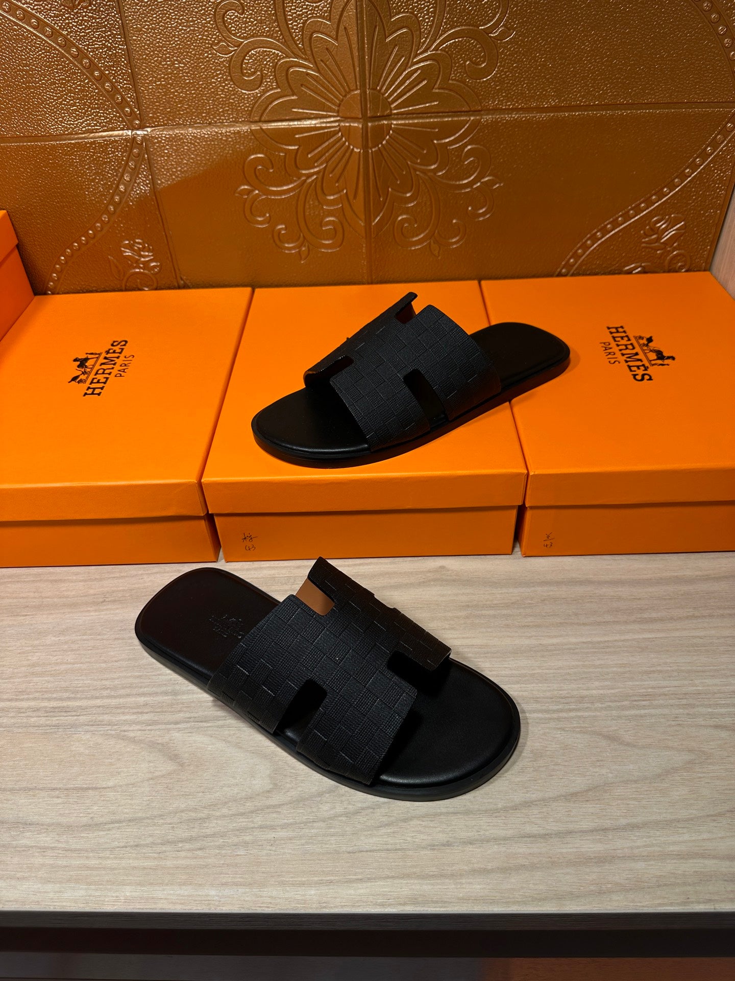 Black slide sandals pair with textured cross straps