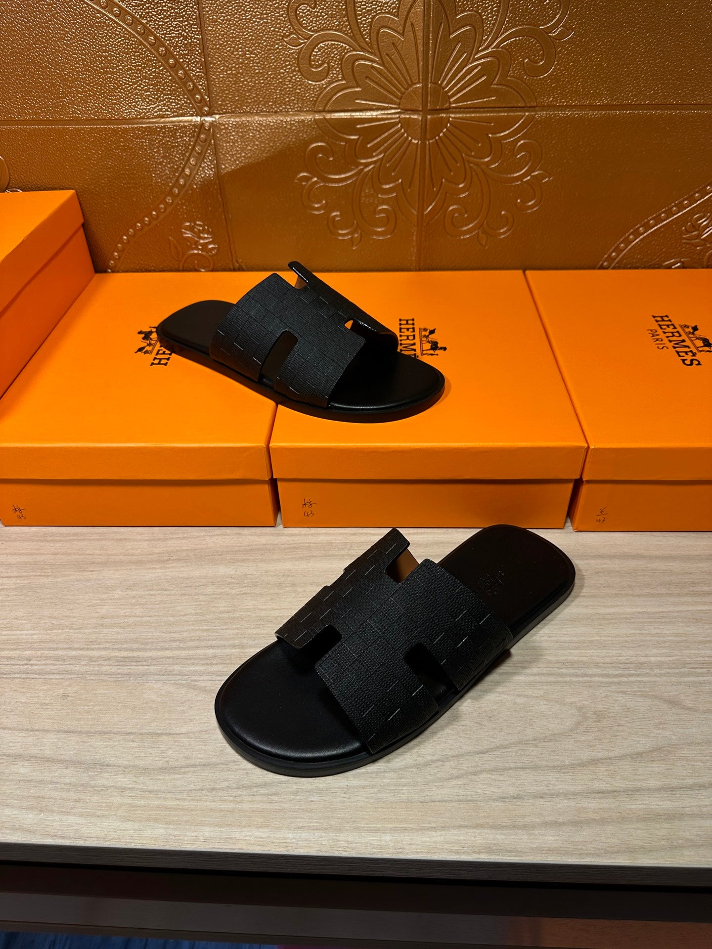 Black slide sandals pair with textured foot straps