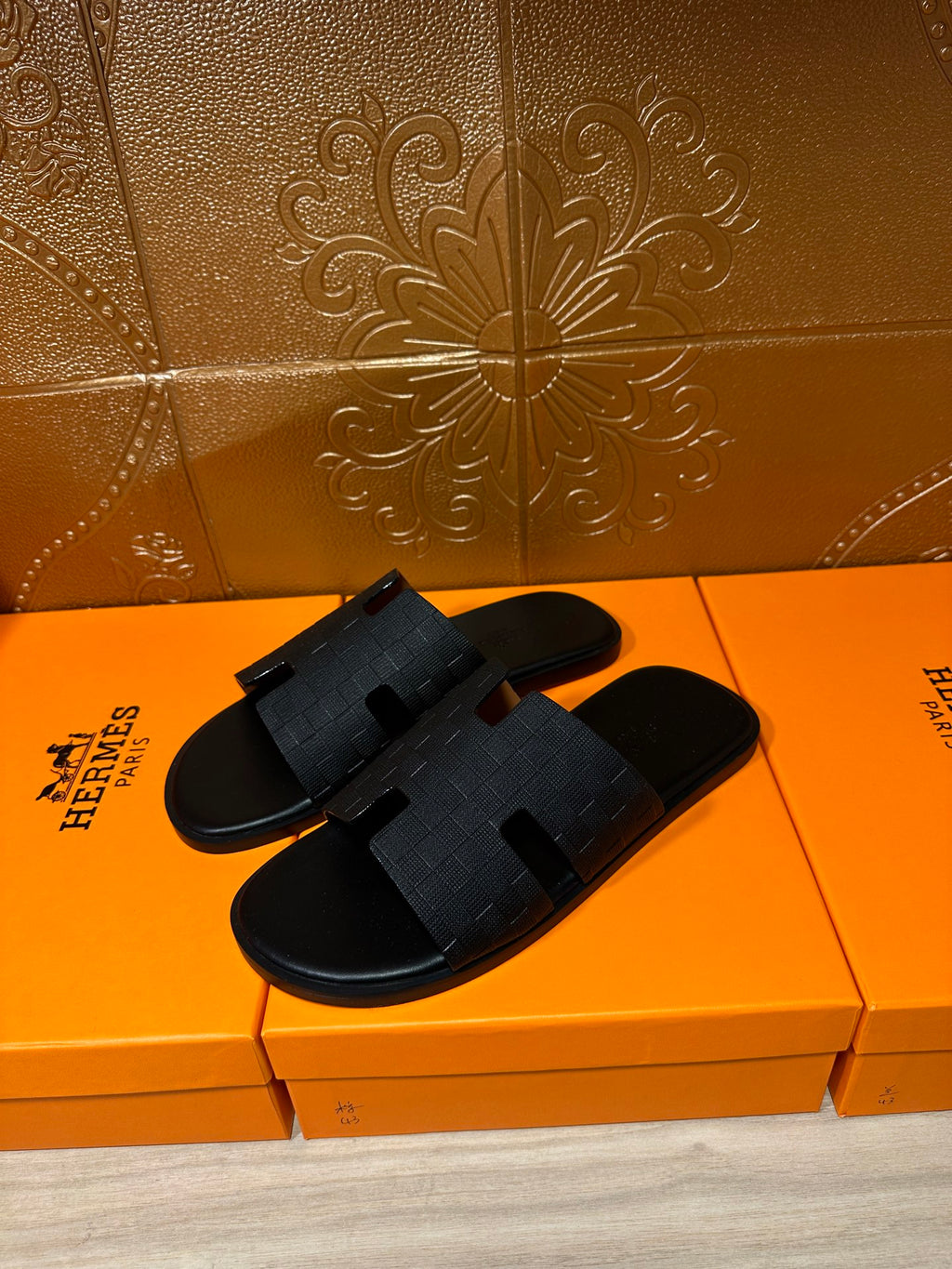 Black slide sandals with wide crossover textured straps
