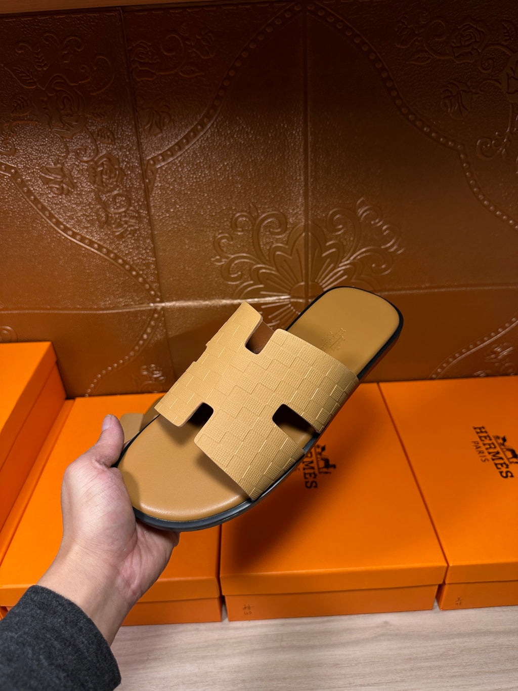Beige slide sandals, close view of textured cross strap upper and sole
