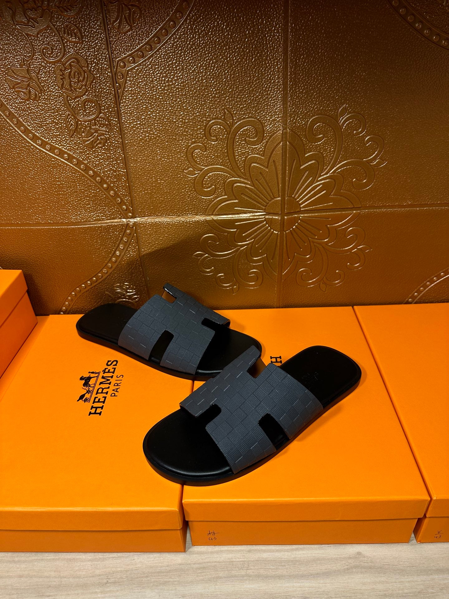 Hermes dark blue slide sandals with molded H cutout strap over black sole