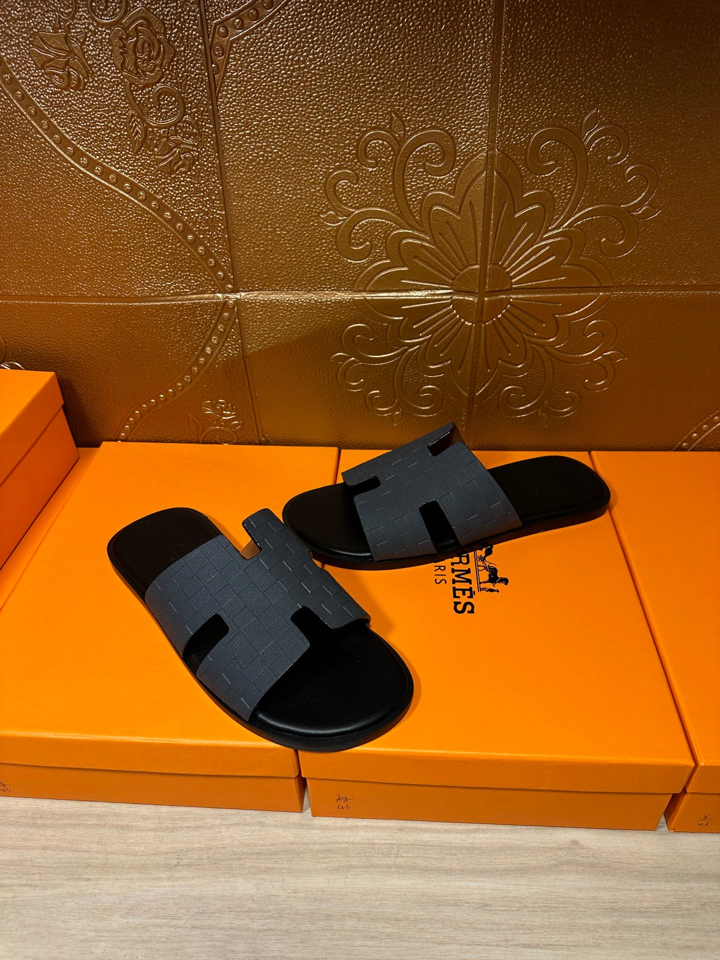 Hermes slide sandals in dark blue with wide strap and open-toe design