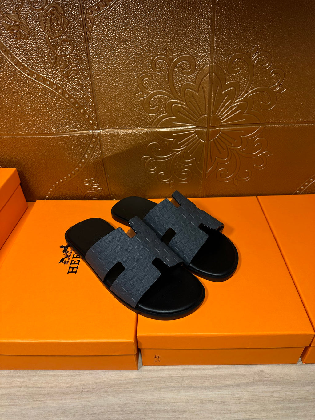 Hermes dark blue slide sandals with wide molded H band and black footbed