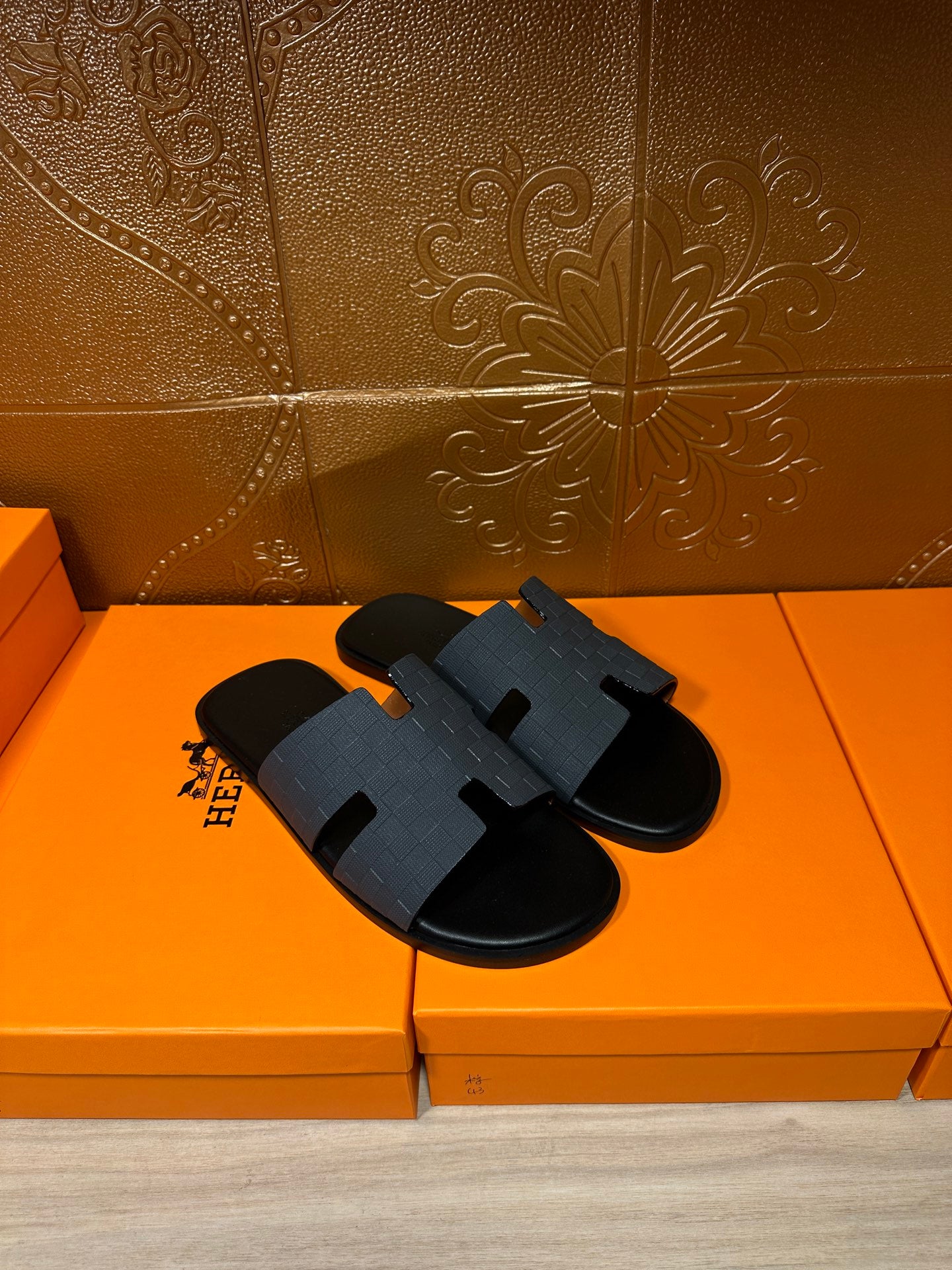 Hermes dark blue slide sandals with wide molded H band and black footbed