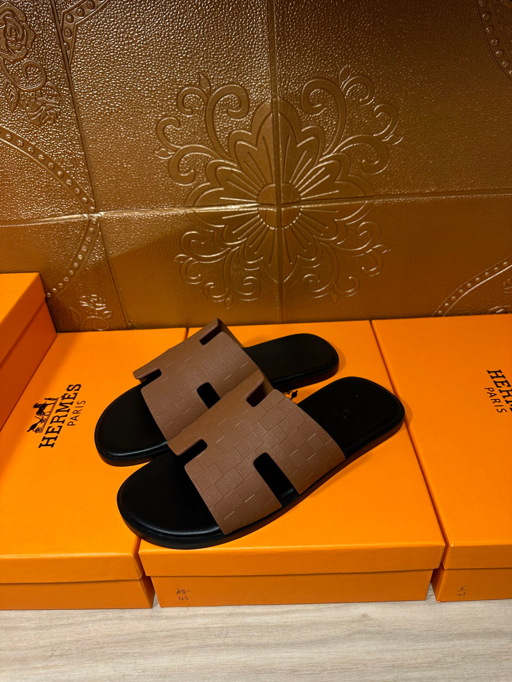 Tan leather slide sandal with black footbed and H-style strap detail