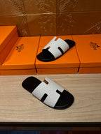 Hermes slide sandals with white straps and black footbed, H-cutout detail