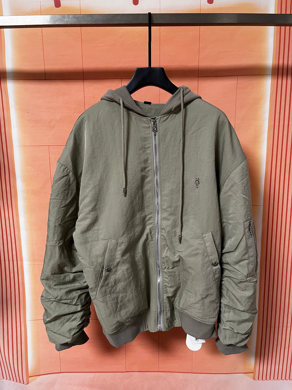 Olive green zip-up hooded jacket with drawstring and front pockets