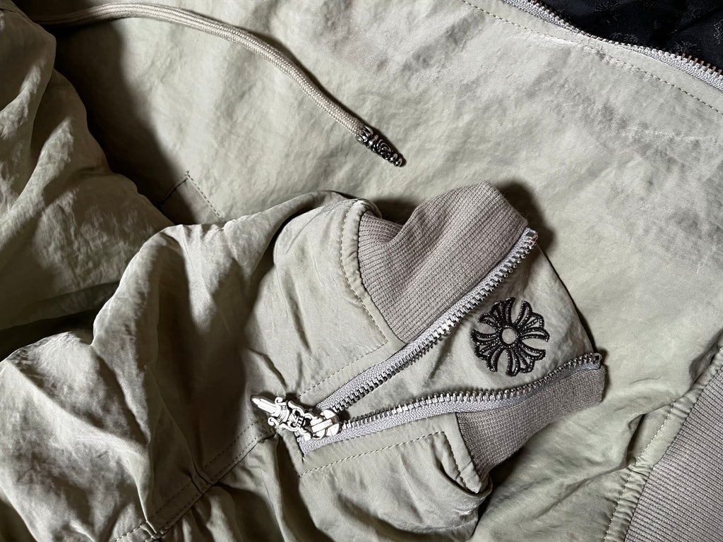 Light gray jacket with front zipper pocket and butterfly patch on chest