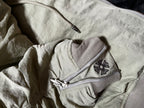 Light gray jacket with front zipper pocket and butterfly patch on chest