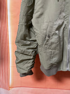 Olive green jacket with angled pocket and elastic cuff detail