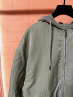Olive green zip-front hooded jacket with drawstring and long sleeves