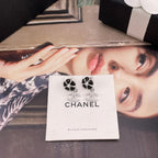 Chanel earrings on card with black flower studs, faux pearl and CC drop charms