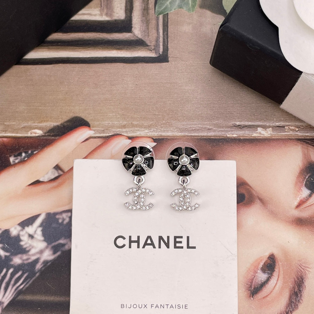 Chanel earrings on card: black flower tops with faux pearl and dangling CC charms