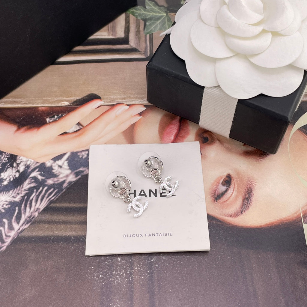 Chanel earrings on card: silver flower studs with faux pearl and CC drop charms