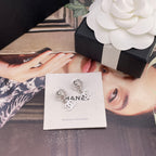 Chanel earrings on card: silver flower studs with faux pearl and CC drop charms
