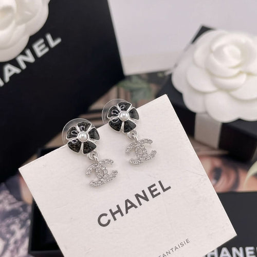 Chanel earrings on brand card, black flower studs with pearl center and CC drop charms