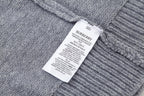 Grey knit sweater with crew neck and Burberry logo patch label